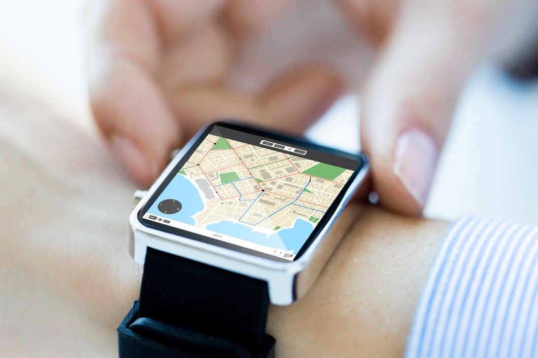 close up of hands with map on smartwatch screen