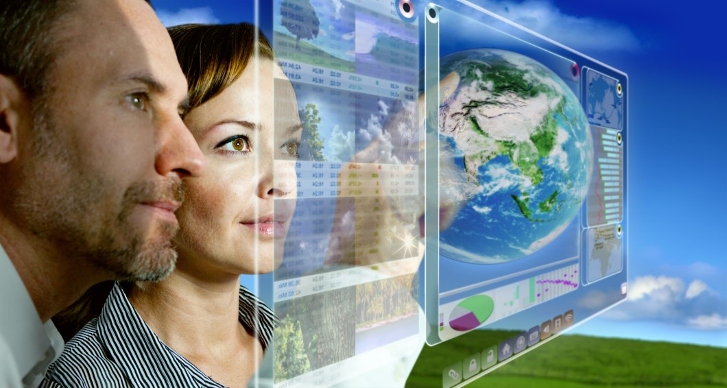 man and woman are working with futuristic screen